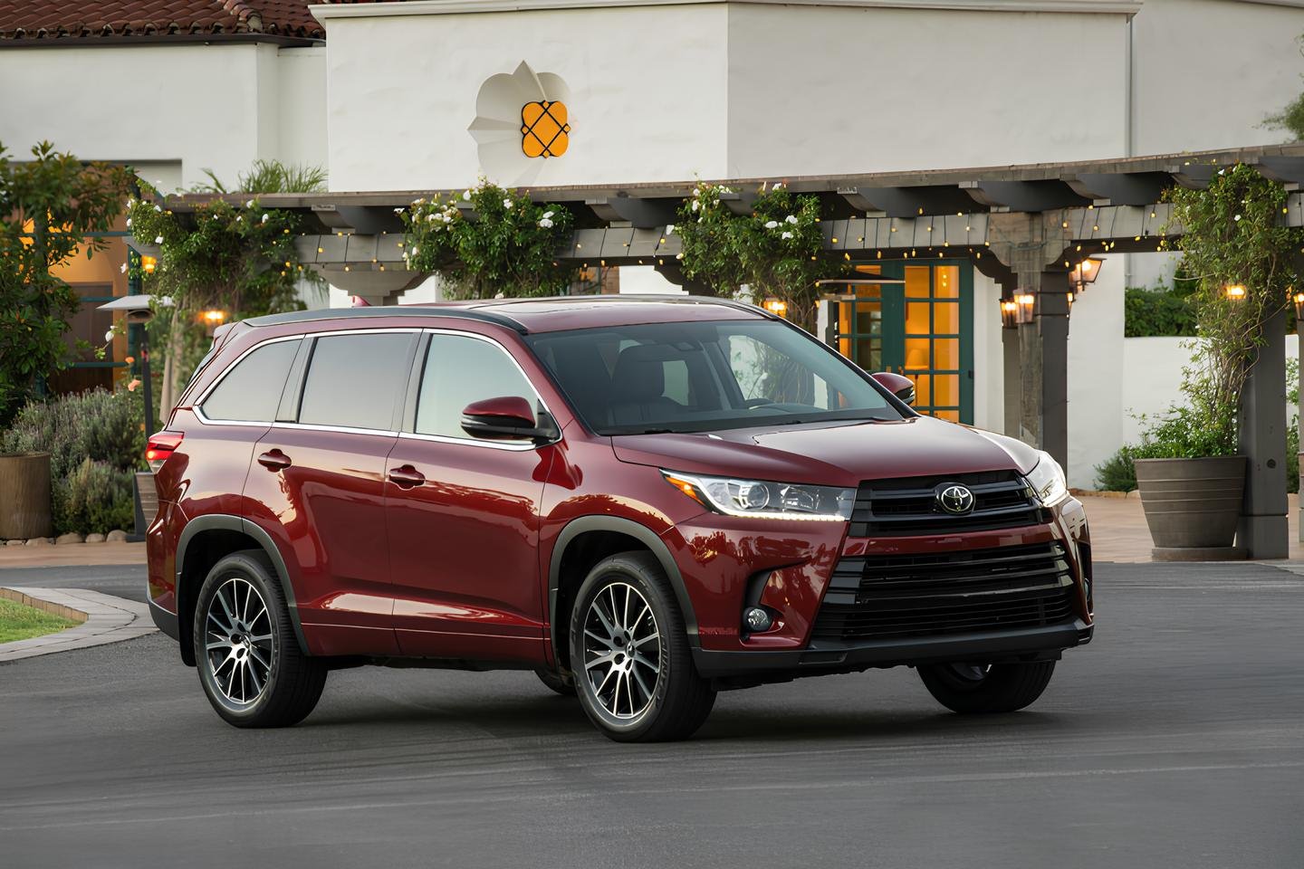 A 2018 Toyota Highlander Hybrid SUV parked in front of a building