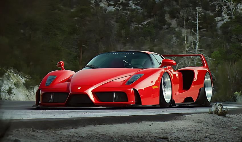  A powerful red Ferrari Enzo sports car parked on a winding road.