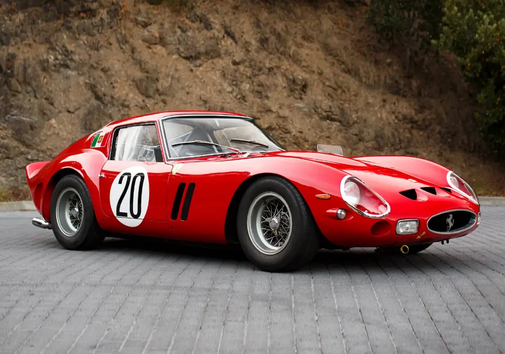 A classic red Ferrari 250 GTO sports car parked on a surface.