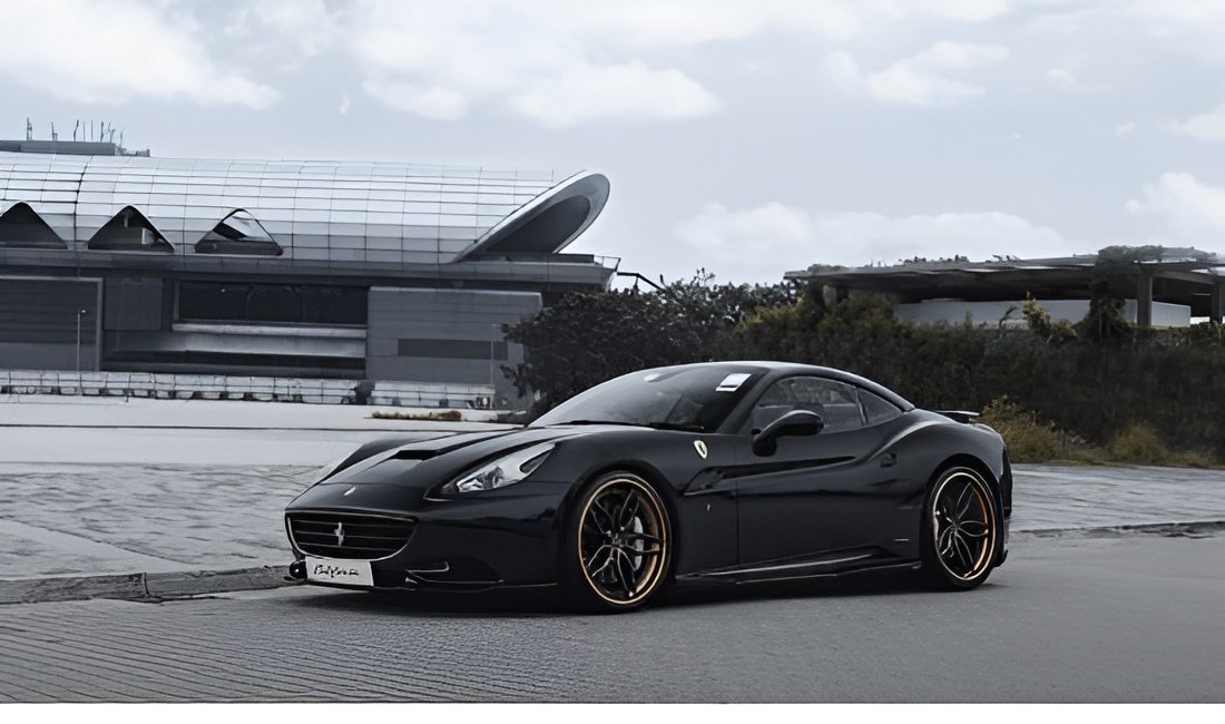 A black Ferrari California parked under overcast skies.