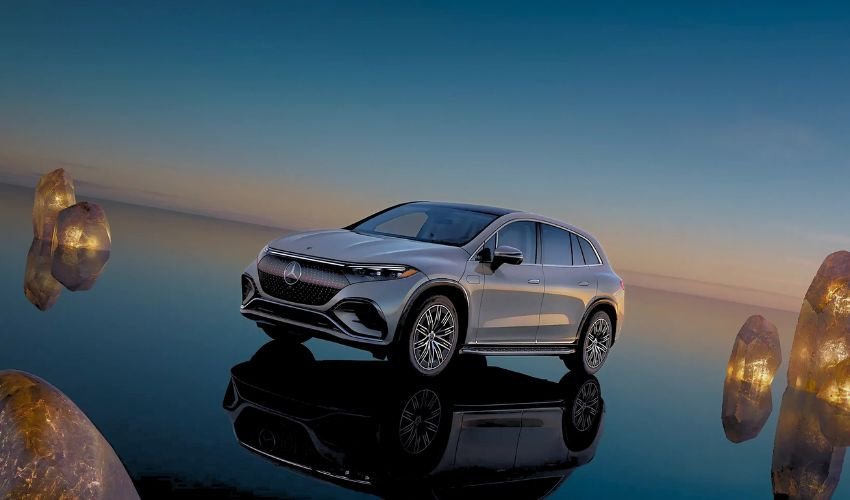 A silver Mercedes-Benz EQS SUV appears to be floating above a reflective surface