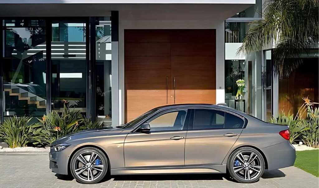 A BMW parked in front of a house