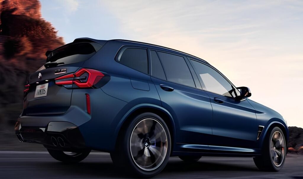 A blue BMW X3 M driving on a road with a rocky landscape in the background.