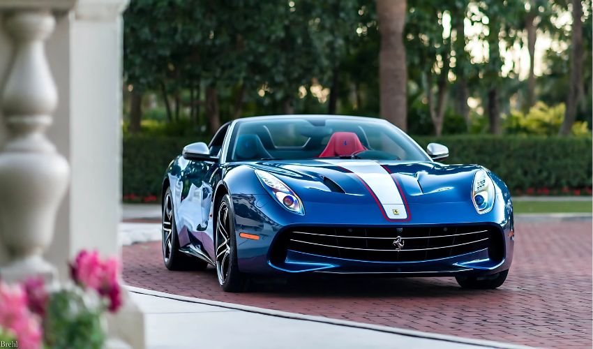 Blue Ferrari F60 America parked in a lush, tropical setting.