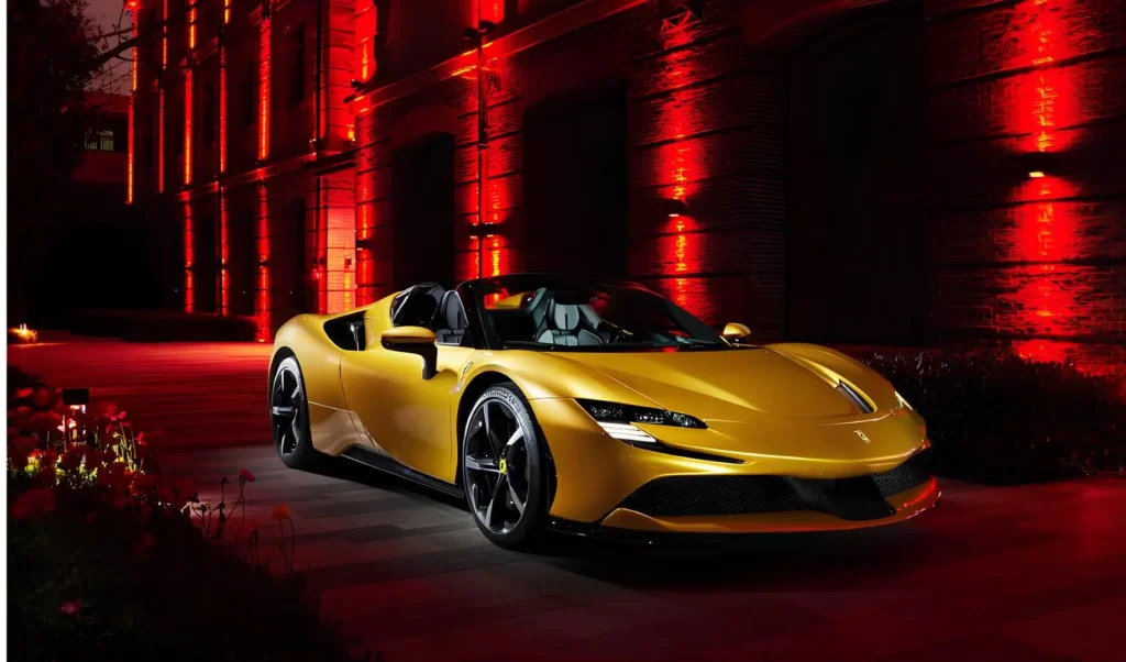 A yellow Ferrari convertible sports car parked under ambient lighting