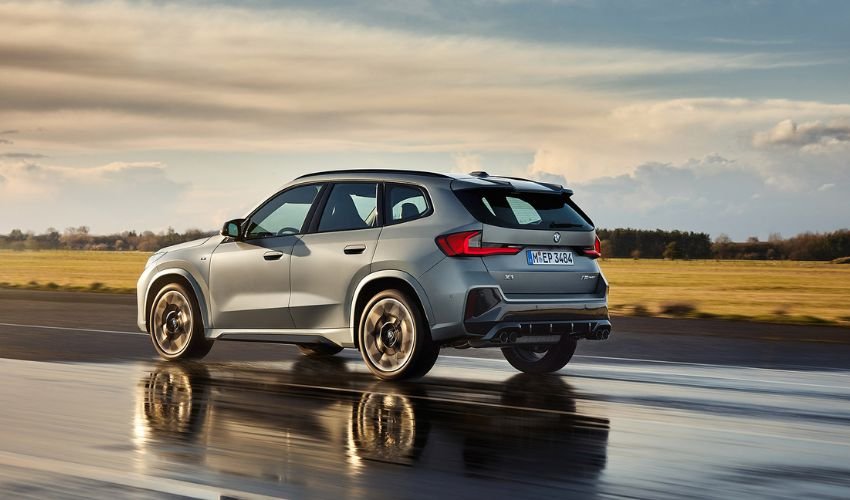 Sleek and athletic BMW X1 SUV navigating through a scenic countryside.