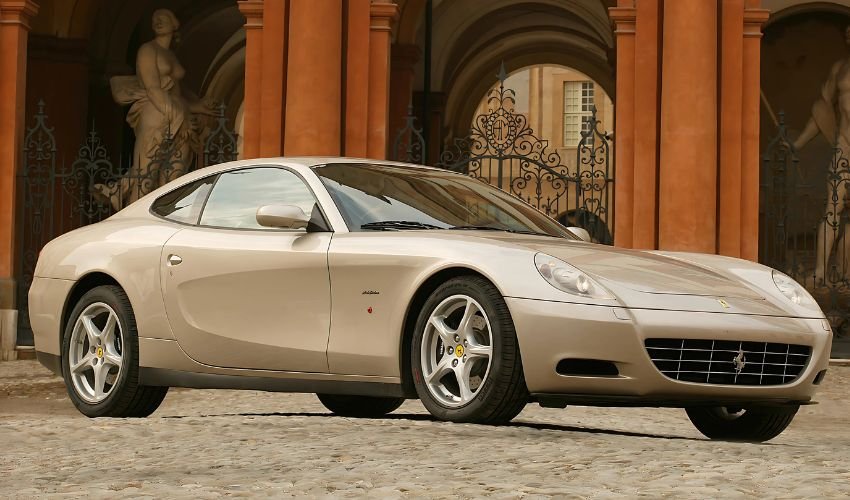 Ferrari 612 parked by ornate classical building