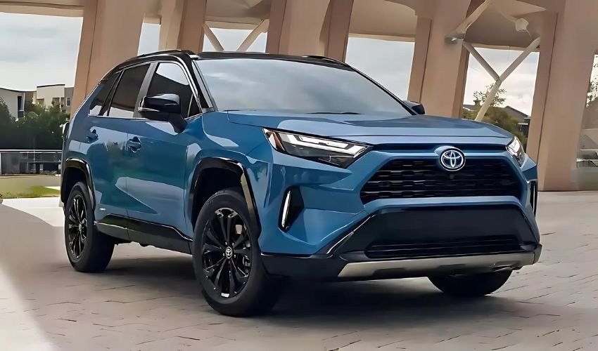 A sleek, blue Toyota RAV4 SUV parked in front of a building.