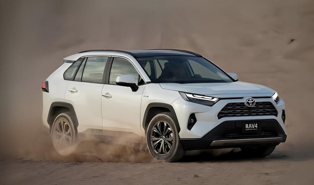 A silver Toyota RAV4 SUV kicking up dust.