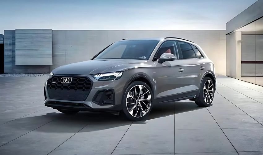 A sleek gray Audi crossover SUV parked in front of a modern building.