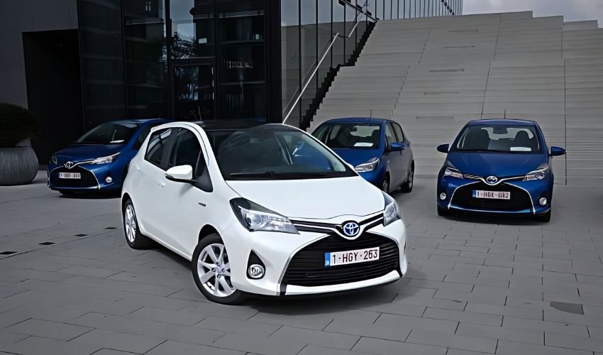 Toyota models displayed in front of a modern building.