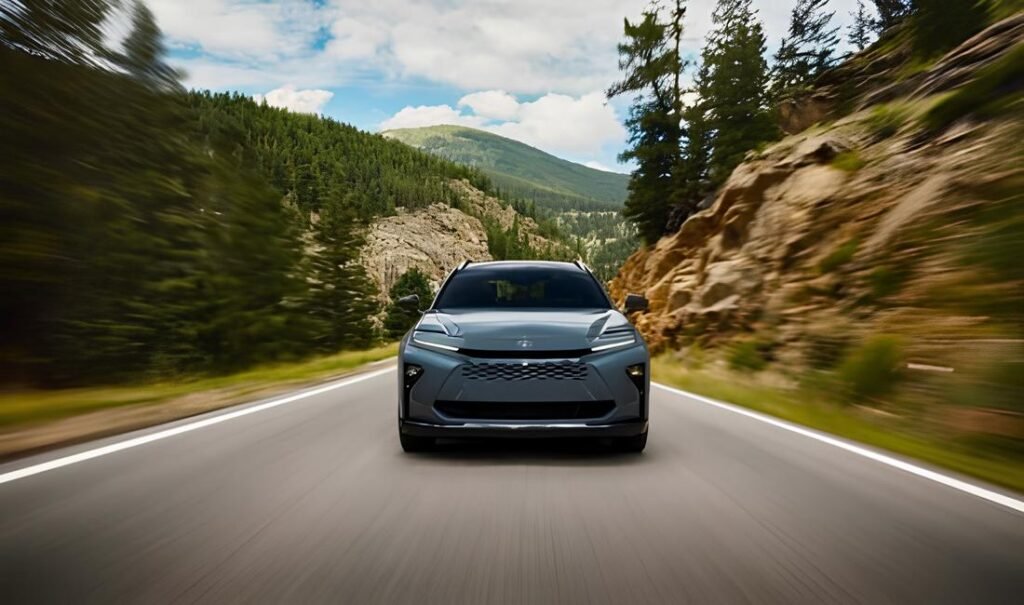 A sleek 2025 Toyota Crown driving through a picturesque mountain landscape.