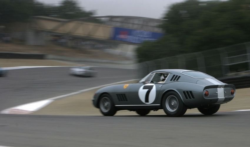 Classic Ferrari 275 race car driving around a track.